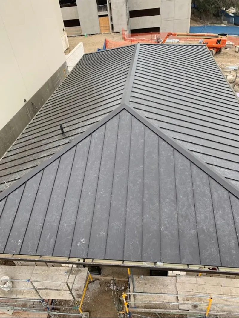 Commercial metal roof construction with crane equipment in Limerick